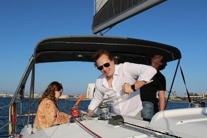 A sailboat on the water with people on board. 2
