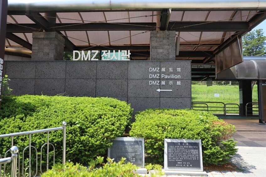 A building entrance with signage for DMZ Pavilion and DMZ Exhibition Hall. 3