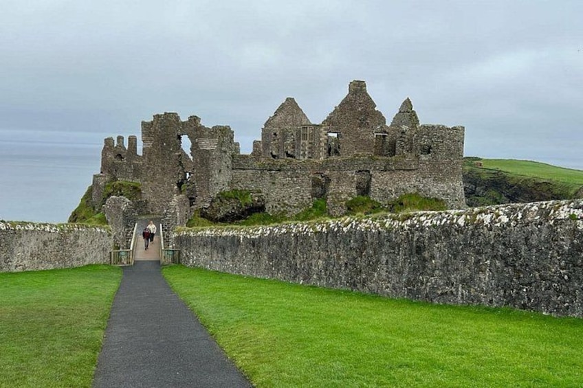 A historic stone castle with a pathway leading to its entrance. 4