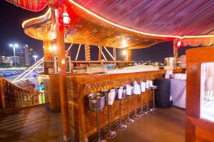 A bar with a wooden structure, a cityscape in the background, and a railing. 5