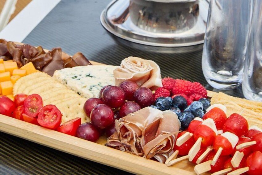 A charcuterie board with various cheeses, meats, and fruits. 4