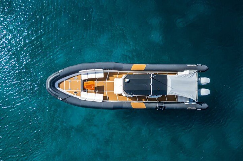 An inflatable boat on clear turquoise water. 1
