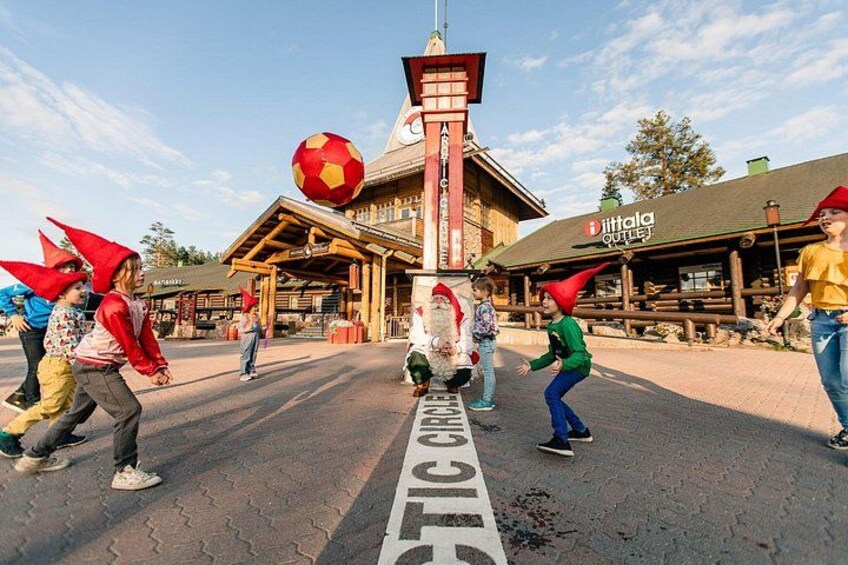 A building with a red and white facade, a large red soccer ball, and a sign that reads 'ittala outlet.' 4