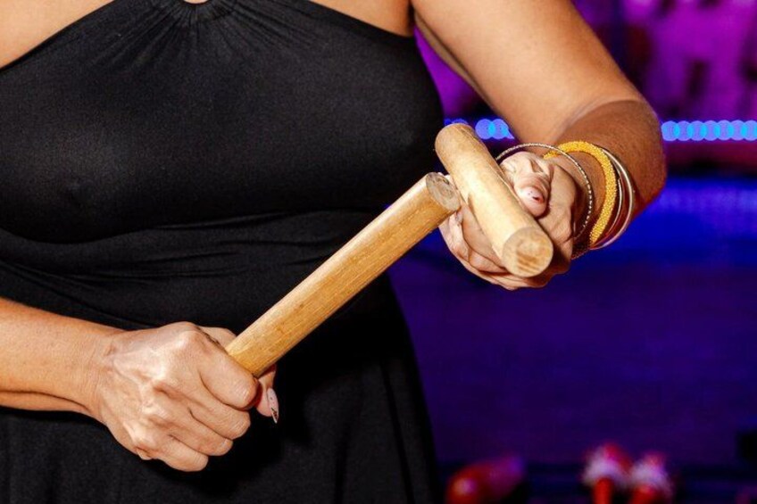 A person holding a wooden mallet. 5