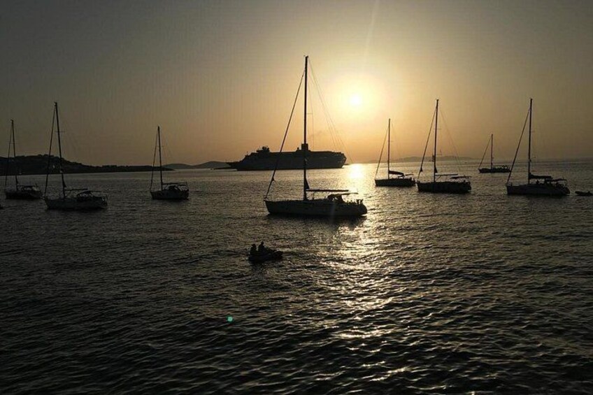 Sailboats on calm water with the sun setting in the background. 3