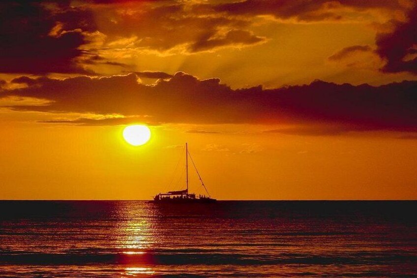 A sunset over the ocean with a boat. 2