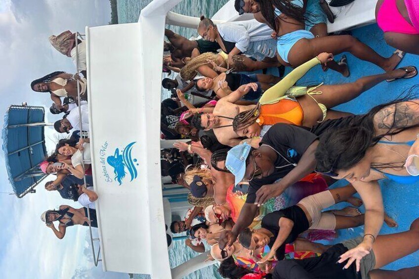 A group of people on a boat with a logo that reads "Sailing the Caribbean." 3