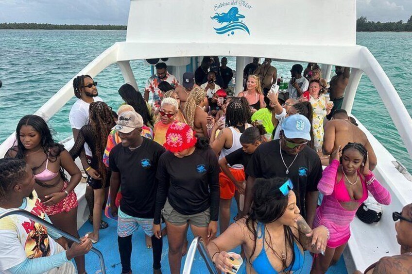 A group of people on a boat with a logo that reads 'Sabina del Mar'. 4