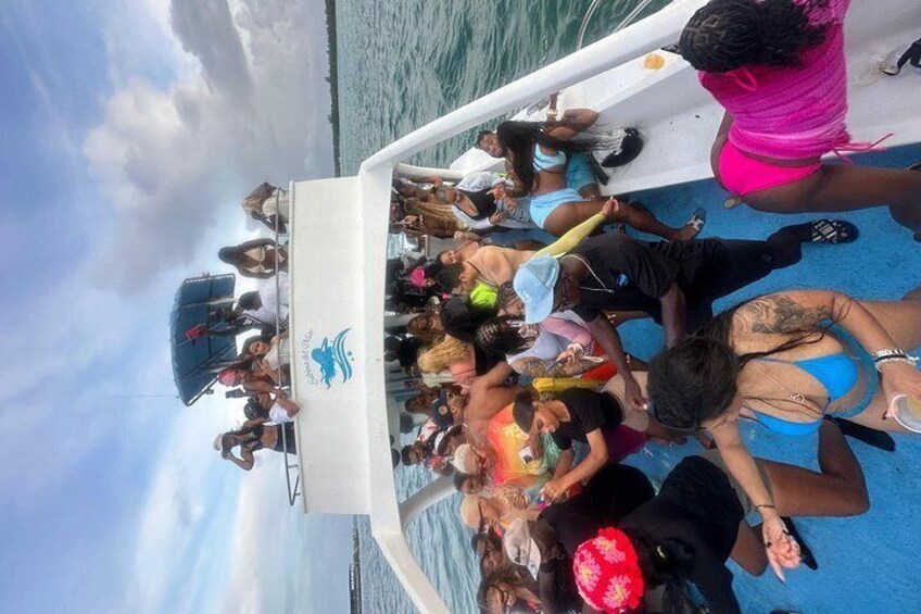A boat with people on board, some wearing hats, and the ocean in the background. 3