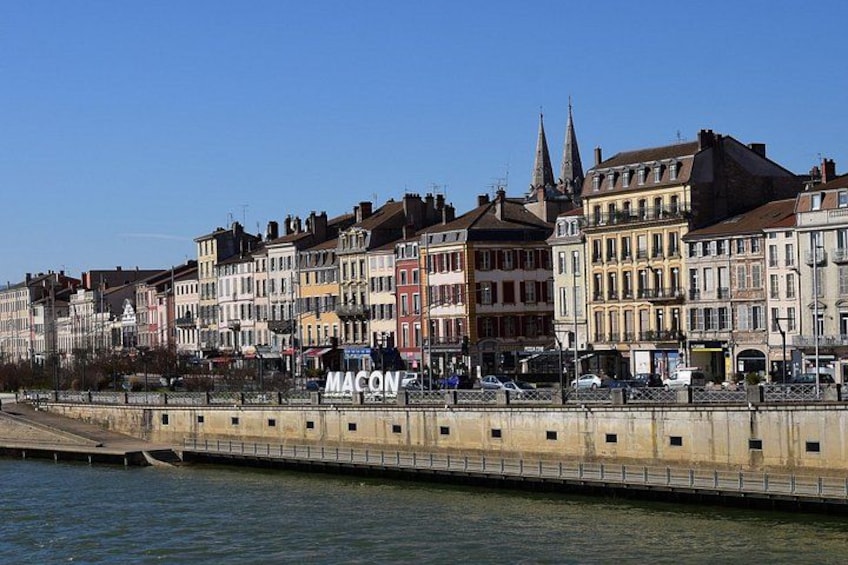 A waterfront with historic buildings and a bridge. 4