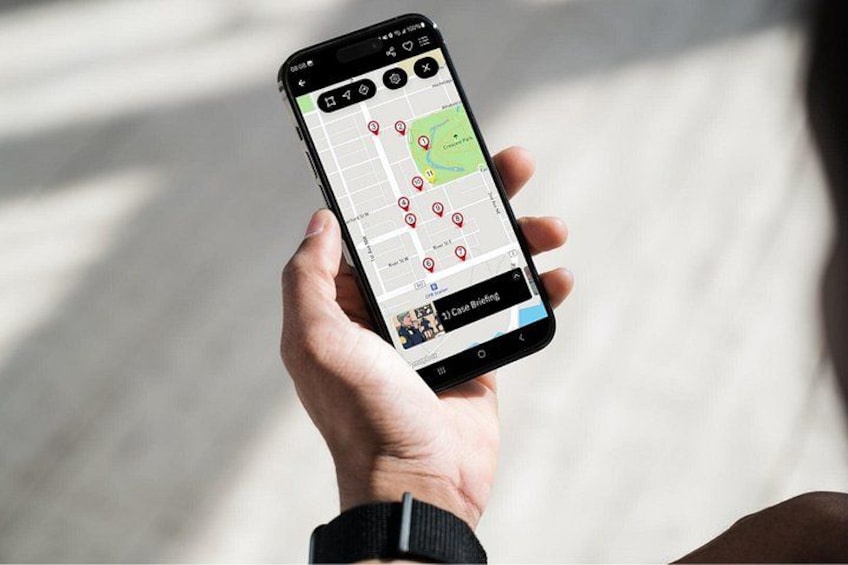 A person holding a smartphone with a map application displaying various locations marked with red pins. 4