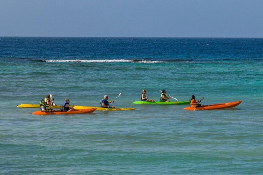 People kayaking on a calm sea. 4