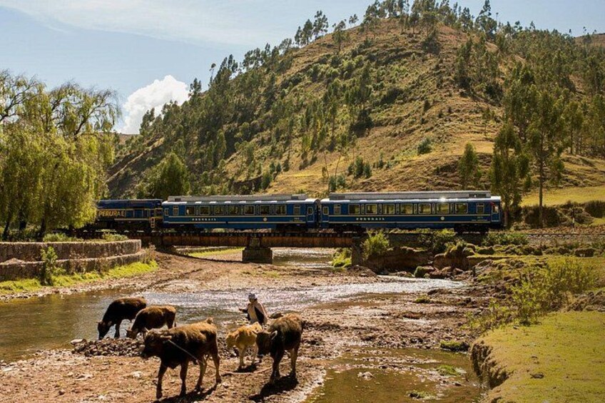 A train crossing a river with a mountainous landscape in the background. 4