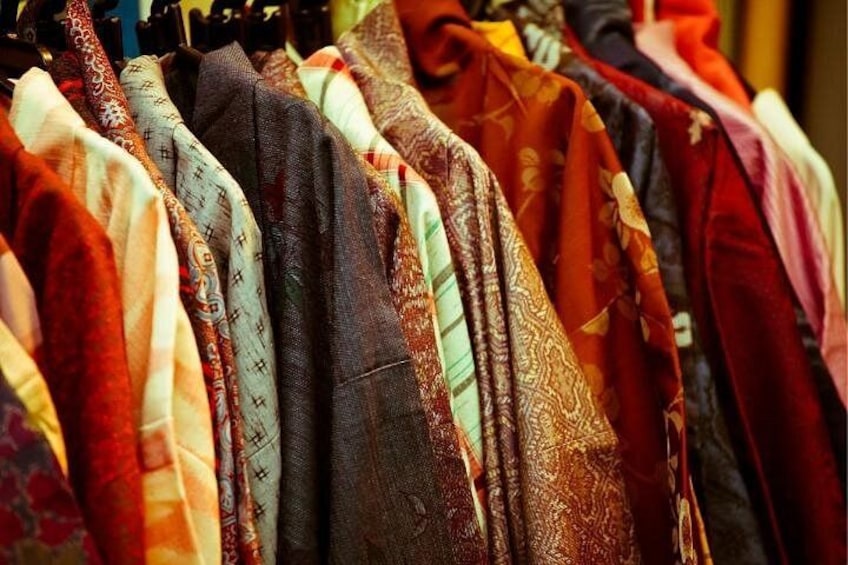 A variety of patterned fabrics displayed on hangers. 4