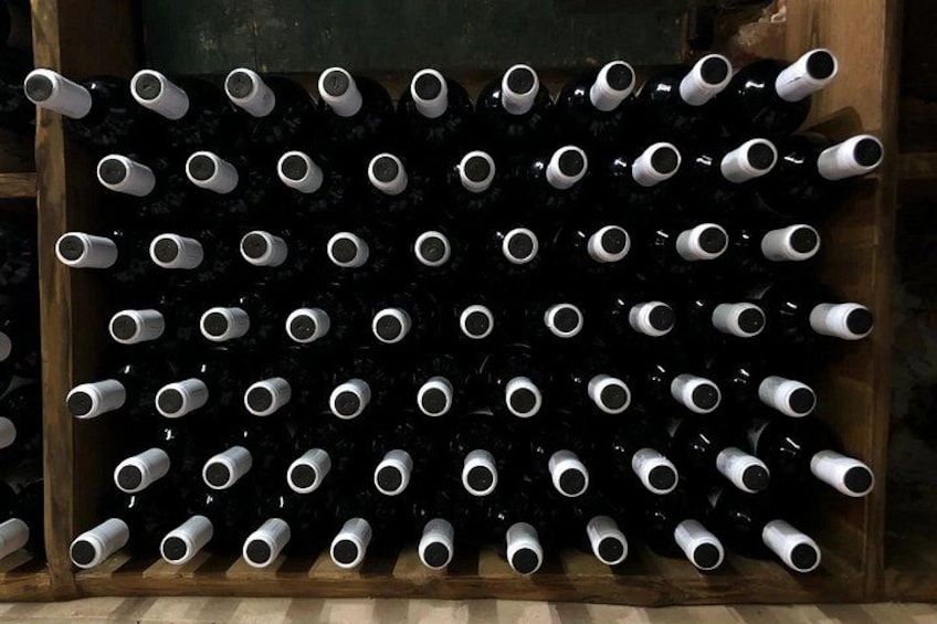 A wine rack with multiple bottles. 3