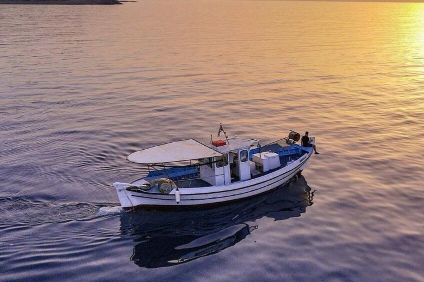 A small boat on calm water during sunset. 3