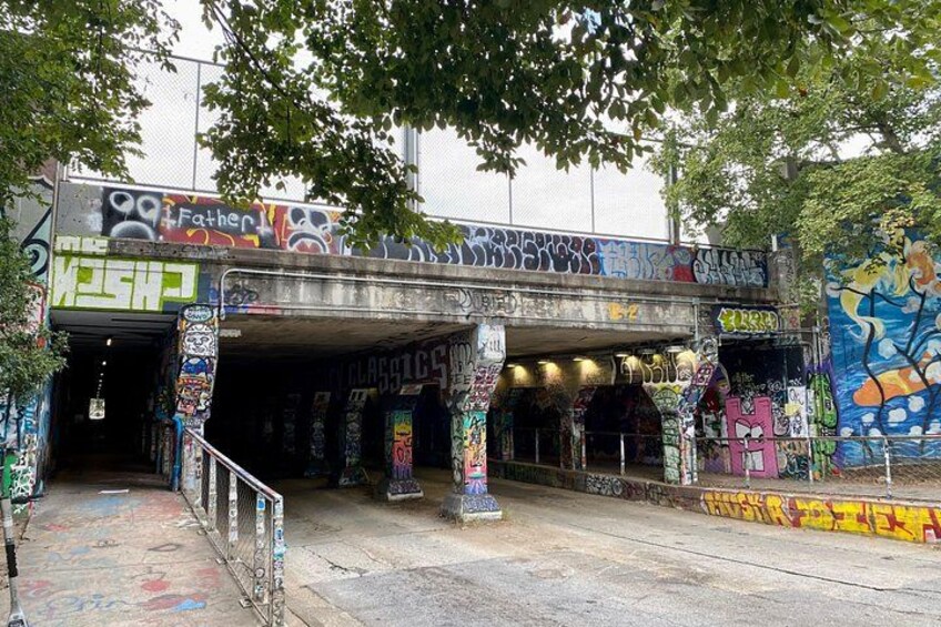 An urban area with graffiti-covered walls and a metal structure. 4