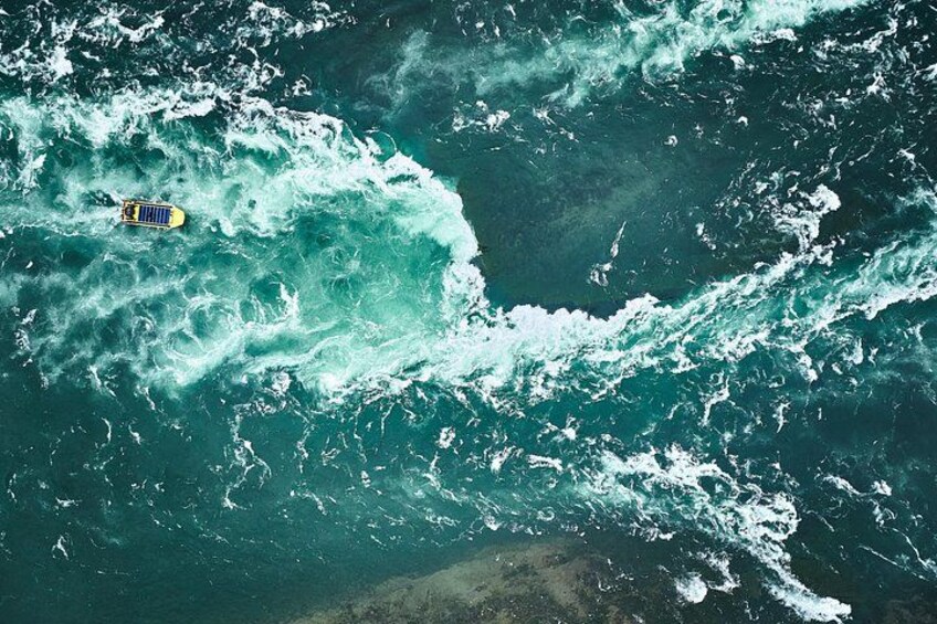 A yellow raft navigating turbulent ocean waters. 1