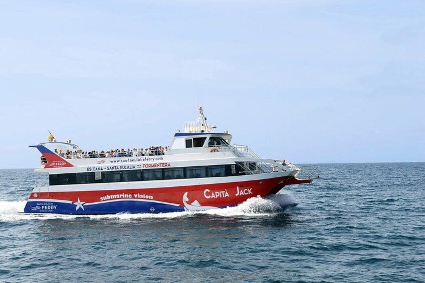 A red and white ferry named 'Capitá Jack' with 'submarine vision' written on its side, sailing on the water. 1