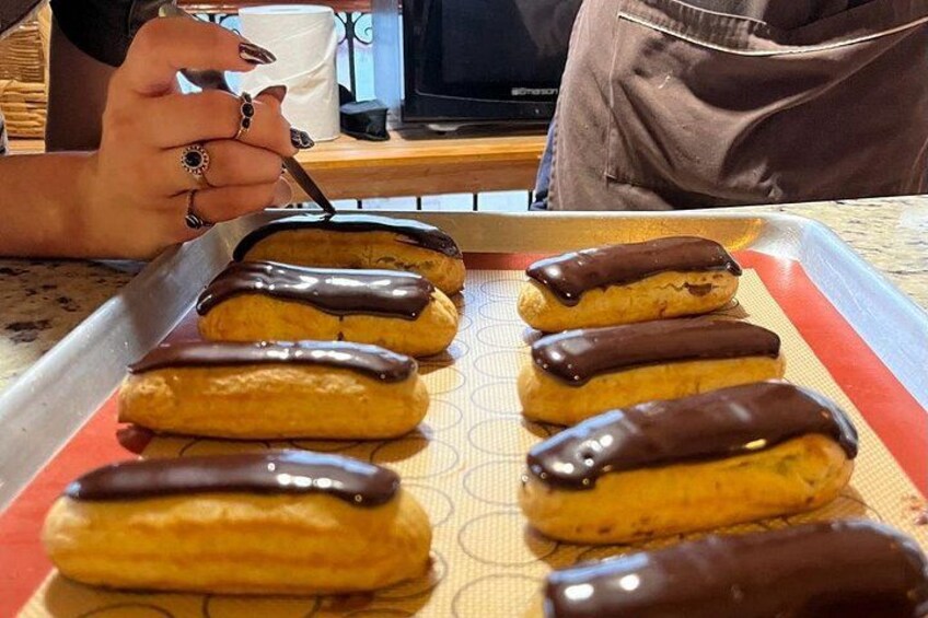 A tray of chocolate-covered pastries on a baking sheet. 1