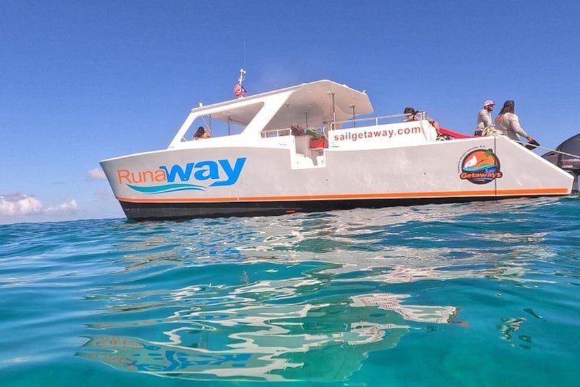 A boat named 'Runaway' with a website 'sailgetaway.com' on the water. 3