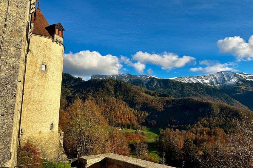 A tower, a valley, and snow-capped mountains. 4