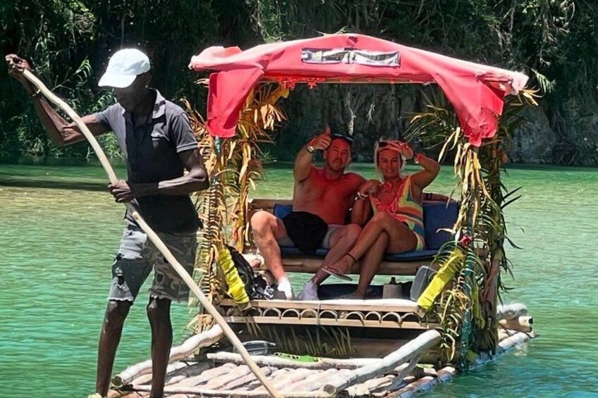 A traditional boat with a canopy, a person rowing, and two passengers. 5