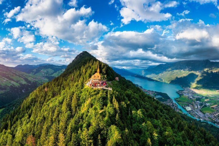 A mountain with a temple on top, a river, and a town below. 5