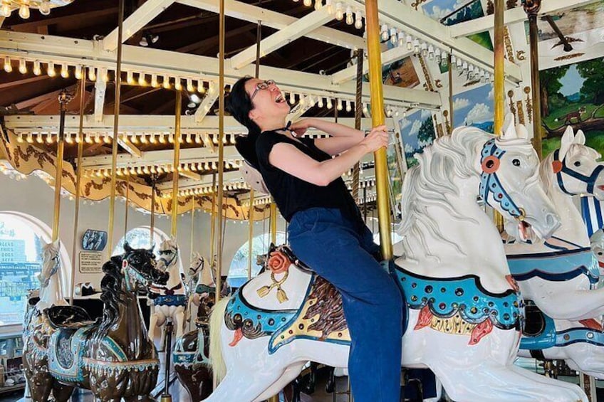 Enjoying a fun ride on the carousel included on our tour! 4