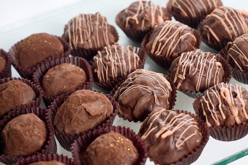 A collection of chocolate truffles in paper cups. 5