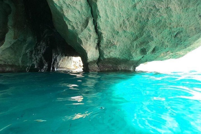 A cave entrance with turquoise water. 2