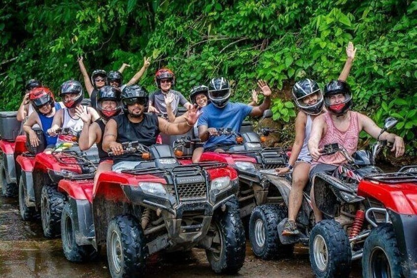 A group of people on ATVs in a forested area. 3