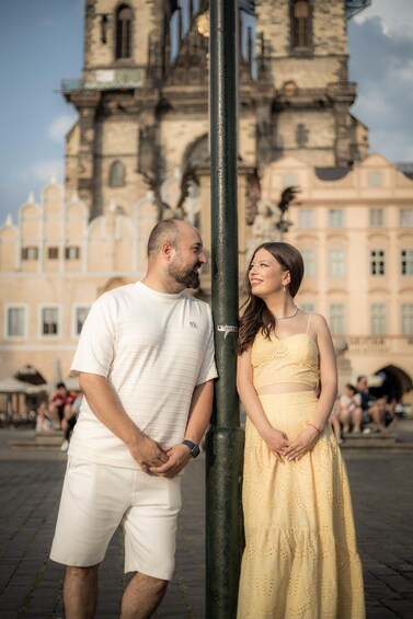 A couple standing in front of a historic building with intricate architecture. 4