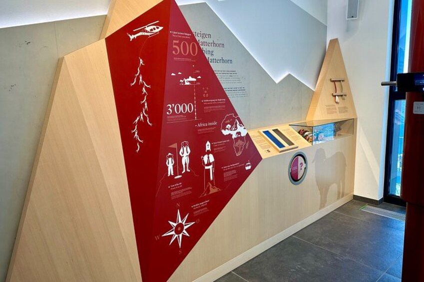 A wooden display with information panels and a star emblem. 3