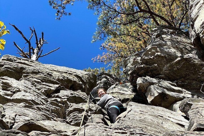 A person climbing a rocky mountain. 1