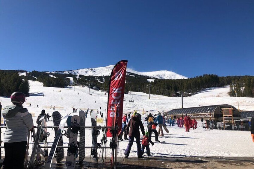 A snowy ski slope with skiers and snowboarders, a red flag, and a building labeled 'Colorado SuperChill'. 5