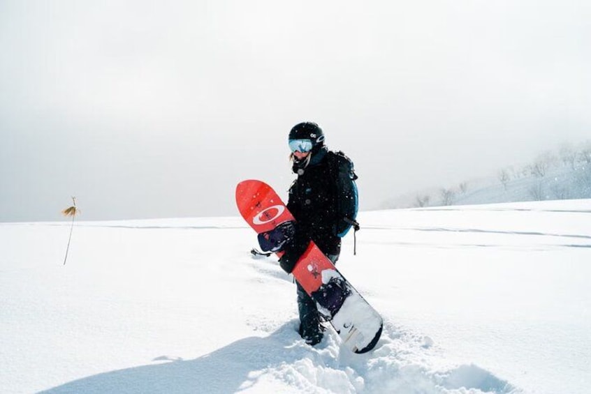A person snowboarding on a snowy slope. 2