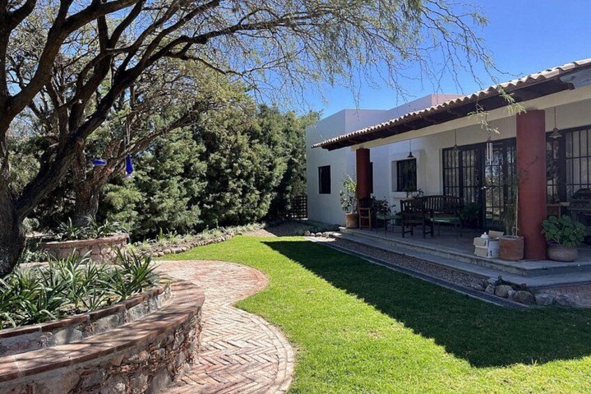A house with a patio, a tree, and a well-maintained lawn. 3