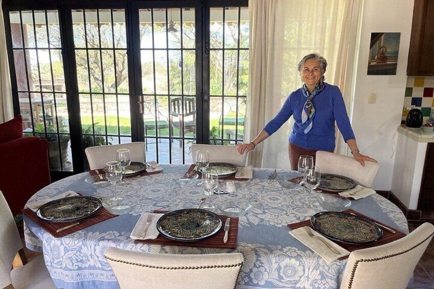 A dining table set for a meal with plates, glasses, and cutlery. 2