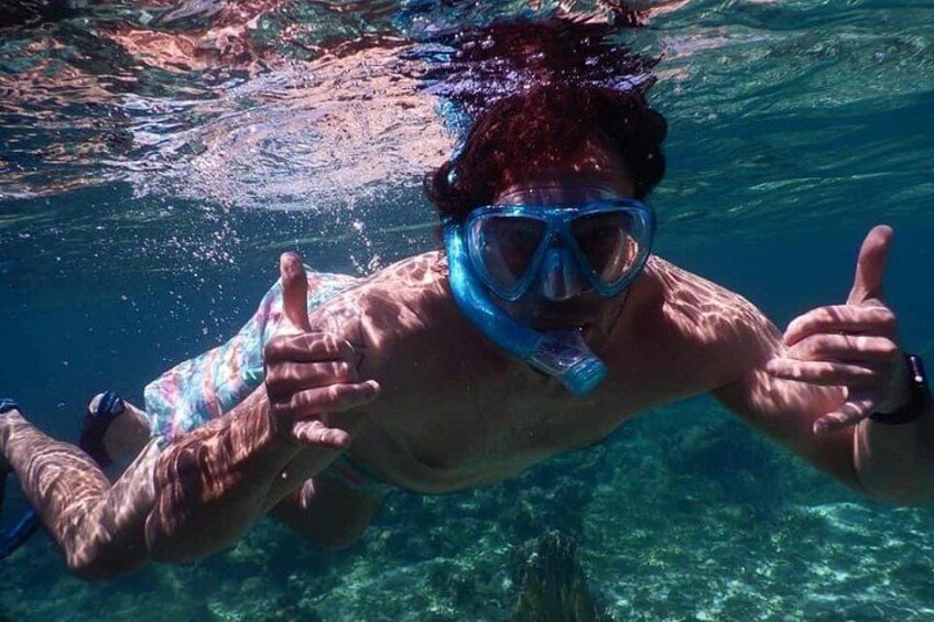 A person underwater giving a thumbs-up. 1
