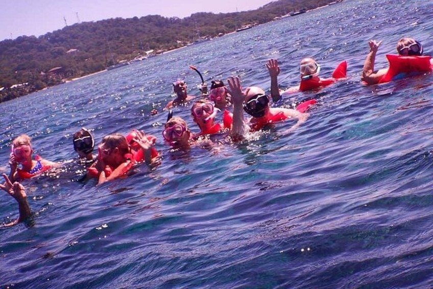 A group of people swimming in the ocean. 2