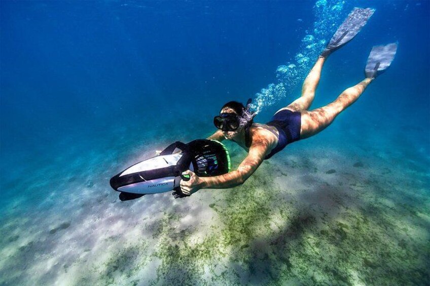 A person snorkeling underwater with fins and a snorkel. 2