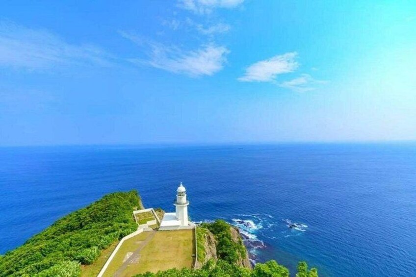 A lighthouse on a cliff by the sea. 1