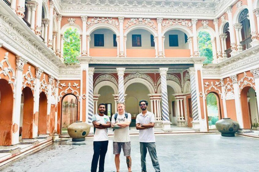 A courtyard with ornate arches, columns, and a large decorative urn. 4