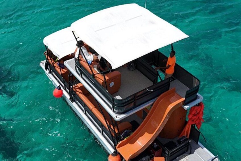 A boat with a white canopy, orange seating, and a red buoy. 5