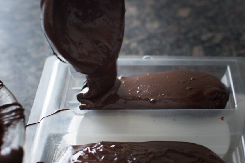 Un cornet de glace enrobé de chocolat, présenté dans un récipient en plastique. 1