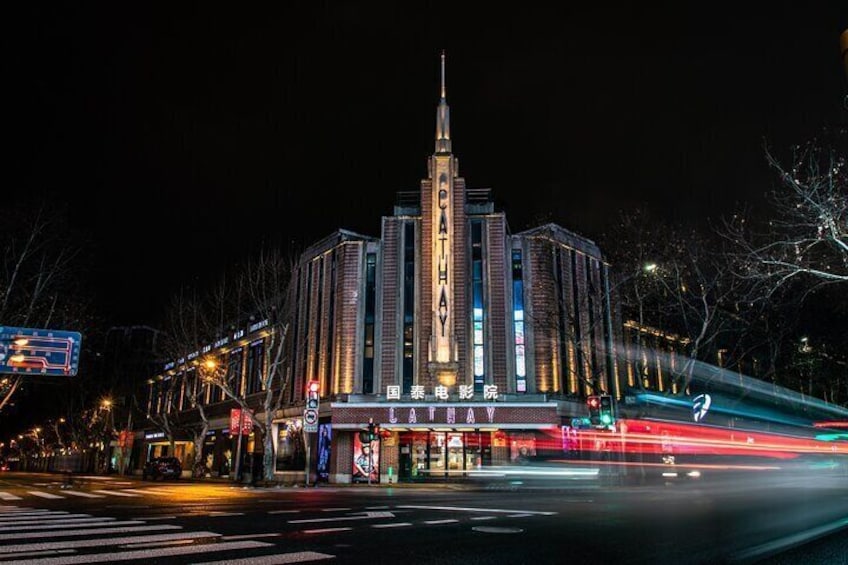 A brightly lit building with the sign "CATHAY" at night. 4