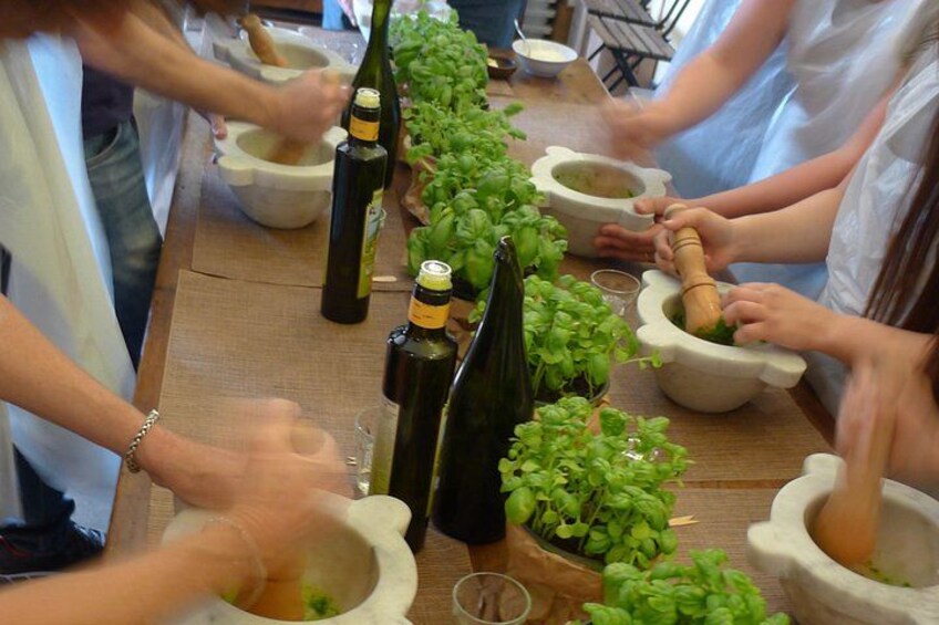 A group of people using mortar and pestle to crush herbs. 1