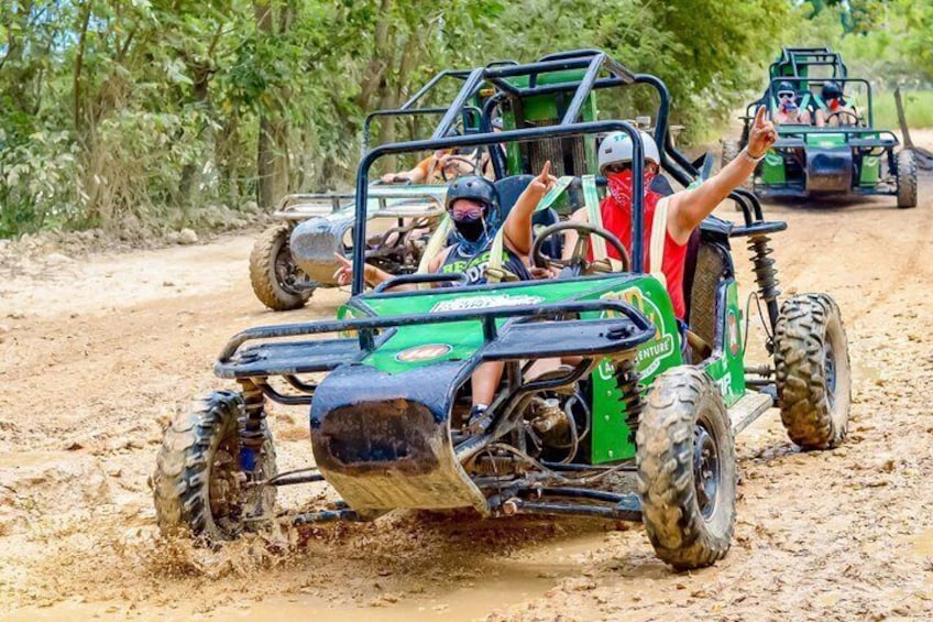 Off-road vehicles on a muddy path with passengers. 1