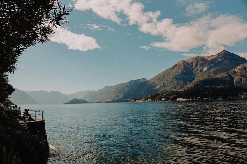 A lake with mountains in the background, a wooden dock, and a clear sky. 2